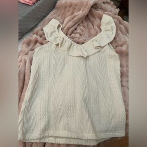 Cute ruffled Women’s sleeveless top.